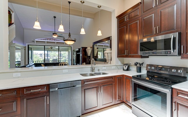 kitchen featuring pendant lighting, ceiling fan, sink, and appliances with stainless steel finishes