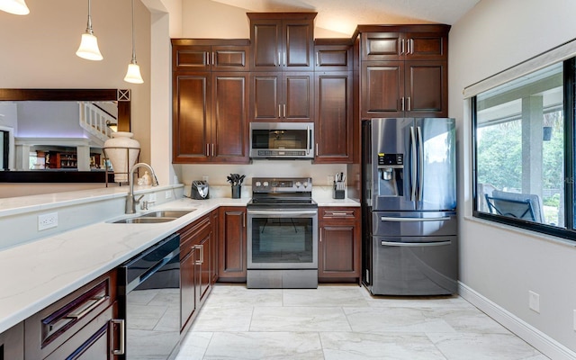 kitchen with pendant lighting, sink, vaulted ceiling, light stone counters, and stainless steel appliances