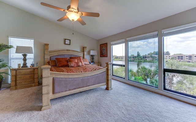 bedroom with carpet flooring, a water view, ceiling fan, and lofted ceiling