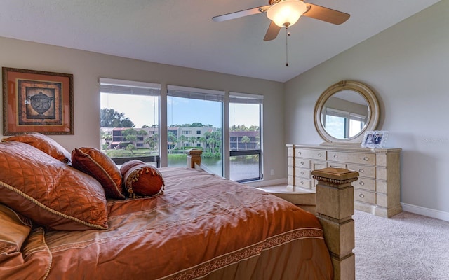 carpeted bedroom with access to exterior, a water view, vaulted ceiling, and ceiling fan