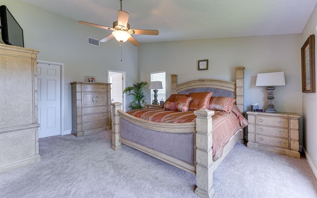 bedroom with light colored carpet, vaulted ceiling, and ceiling fan