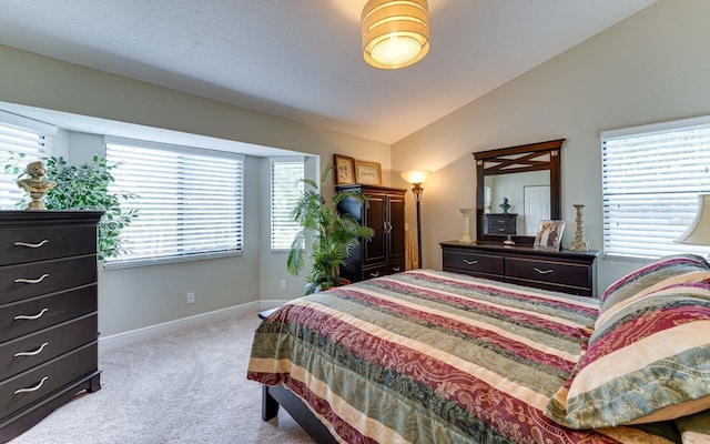 carpeted bedroom with vaulted ceiling