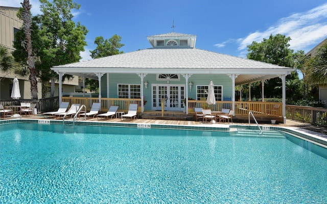 view of swimming pool featuring french doors