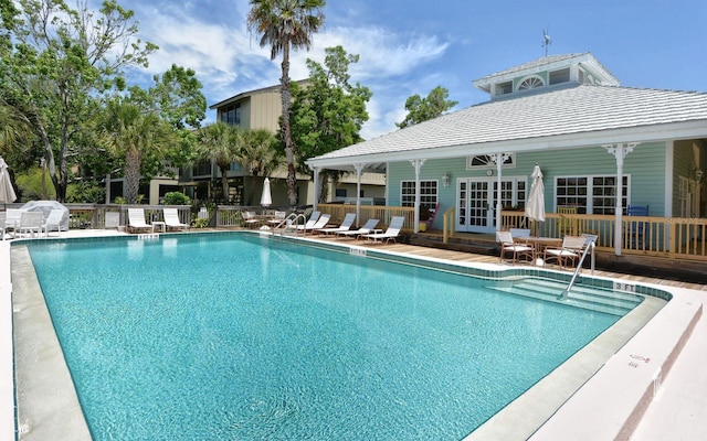 view of swimming pool with a patio area and french doors