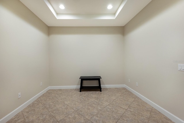 spare room with a raised ceiling