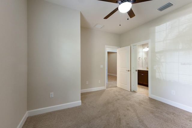 unfurnished bedroom with ensuite bathroom, ceiling fan, and light carpet