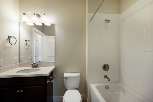 full bathroom featuring toilet, tiled shower / bath combo, and vanity