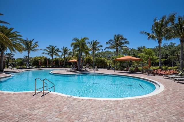 view of swimming pool with a gazebo and a patio area