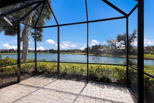 unfurnished sunroom featuring a water view