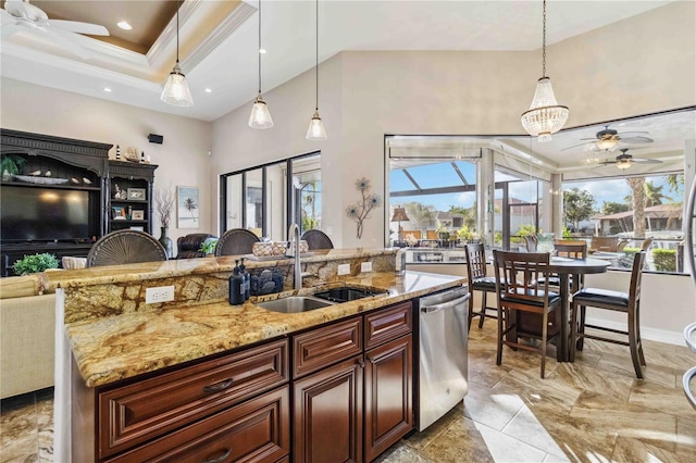 kitchen with dishwasher, pendant lighting, a raised ceiling, and sink