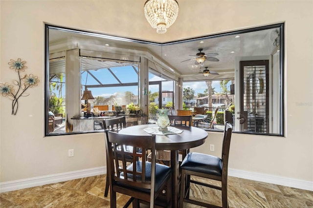 dining space with ceiling fan with notable chandelier