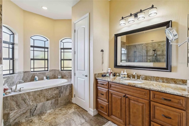 bathroom with vanity and separate shower and tub