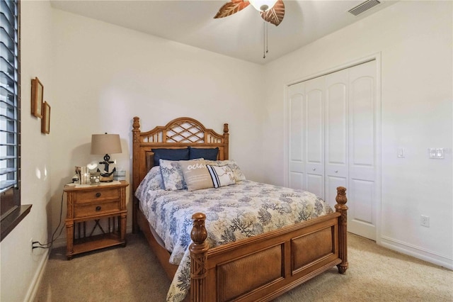 carpeted bedroom featuring ceiling fan and a closet