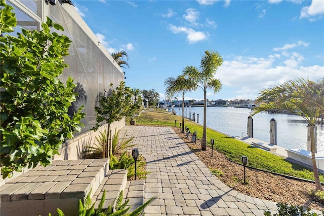 view of patio / terrace featuring a boat dock and a water view