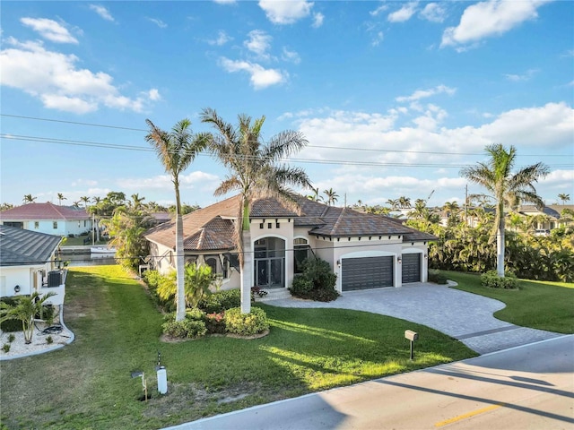 view of front of home featuring a garage and a front lawn