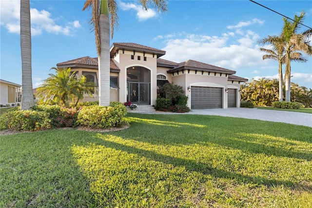 mediterranean / spanish home featuring a garage and a front lawn