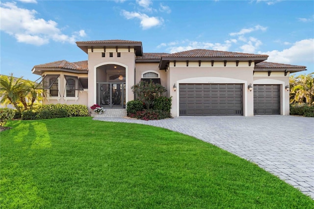 mediterranean / spanish house with a garage and a front yard