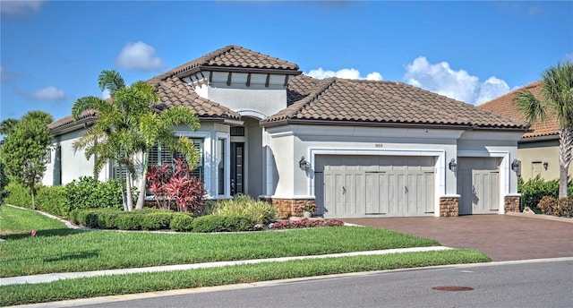 mediterranean / spanish-style home with a garage and a front lawn