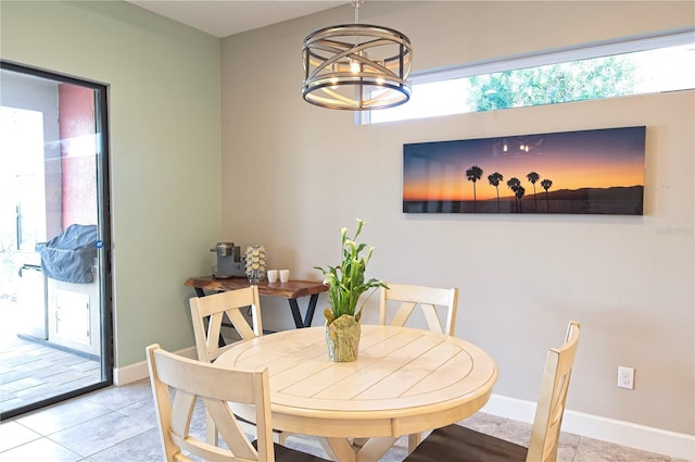 dining room featuring a chandelier and light tile patterned flooring