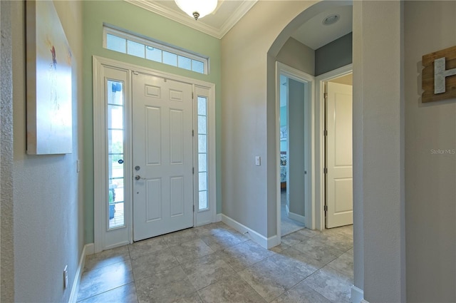 entrance foyer featuring a healthy amount of sunlight and crown molding