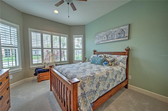 bedroom with ceiling fan and light carpet