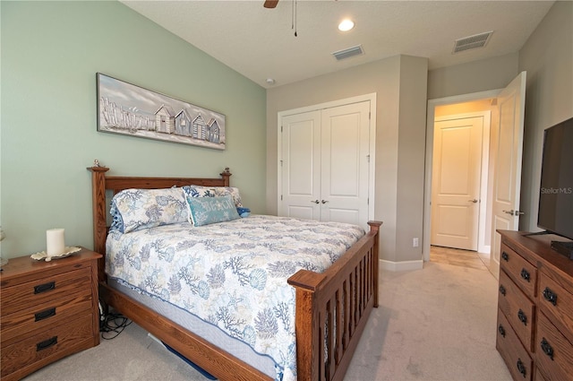 carpeted bedroom with ceiling fan and a closet