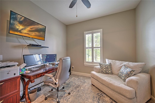 carpeted office featuring ceiling fan