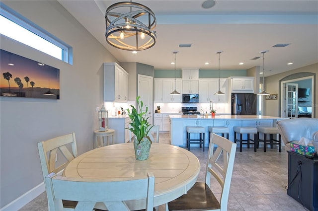 tiled dining room featuring a chandelier