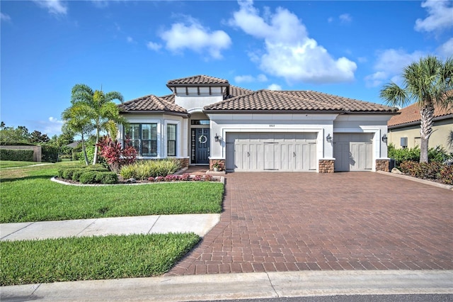 mediterranean / spanish-style house featuring a front yard and a garage