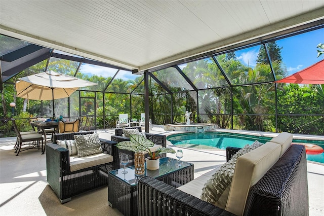 view of pool with a patio area, an in ground hot tub, outdoor lounge area, and glass enclosure