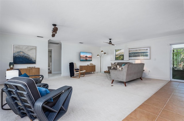 living room with light tile patterned floors, ceiling fan, and ornamental molding