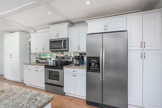 kitchen with light stone counters, white cabinetry, stainless steel appliances, and light tile patterned floors