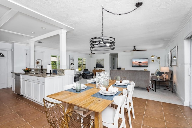 dining room featuring sink, ceiling fan with notable chandelier, dark tile patterned flooring, and ornamental molding