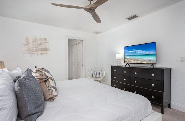 bedroom with ceiling fan, a closet, and light carpet