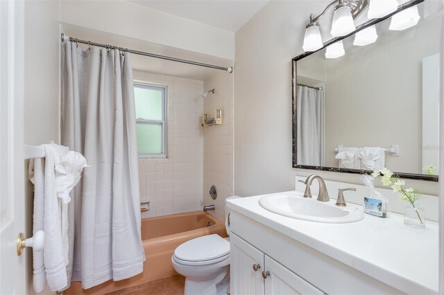 full bathroom featuring vanity, toilet, and shower / bathtub combination with curtain