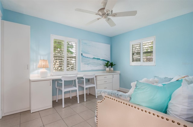 tiled bedroom featuring ceiling fan