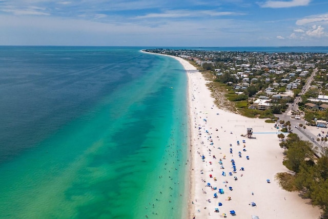 drone / aerial view featuring a water view and a view of the beach