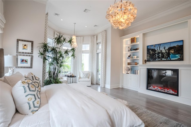 bedroom featuring an inviting chandelier, hardwood / wood-style floors, and crown molding