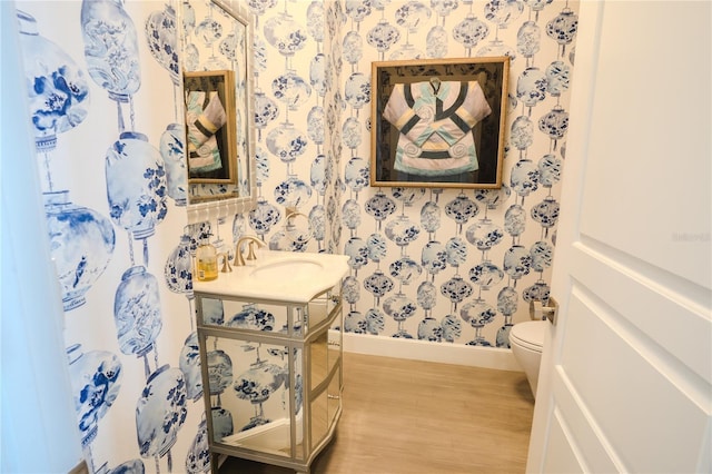 bathroom featuring vanity, hardwood / wood-style floors, and toilet