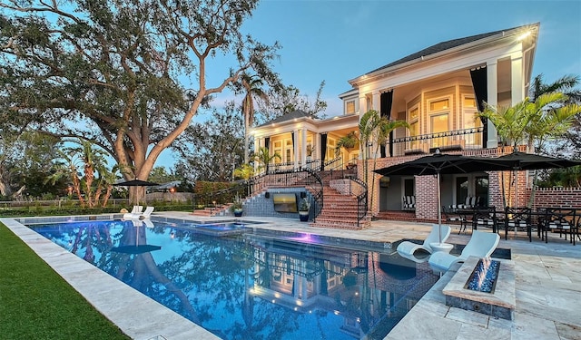 view of swimming pool with an in ground hot tub and a patio area