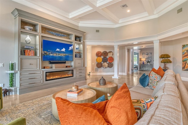 1541 Bay Point Dr, Sarasota, FL 34236 - living area with decorative columns, a glass covered fireplace, coffered ceiling, ornamental molding, and beam ceiling