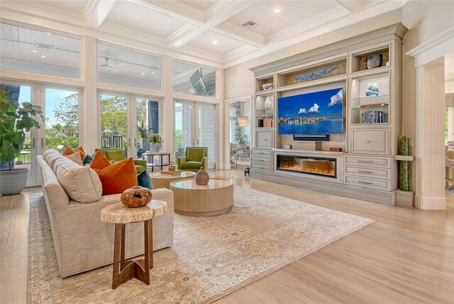 1541 Bay Point Dr, Sarasota, FL 34236 - living area with a glass covered fireplace, healthy amount of natural light, beam ceiling, wood finished floors, and coffered ceiling