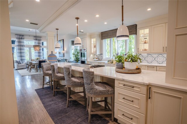 1541 Bay Point Dr, Sarasota, FL 34236 - kitchen with healthy amount of natural light, stainless steel double oven, glass insert cabinets, and recessed lighting
