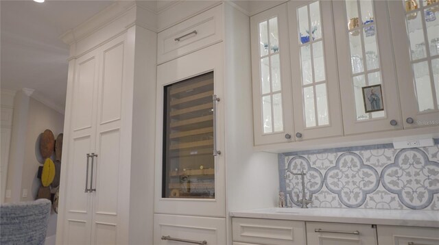1541 Bay Point Dr, Sarasota, FL 34236 - detailed view of decorative backsplash, ornamental molding, and wine cooler