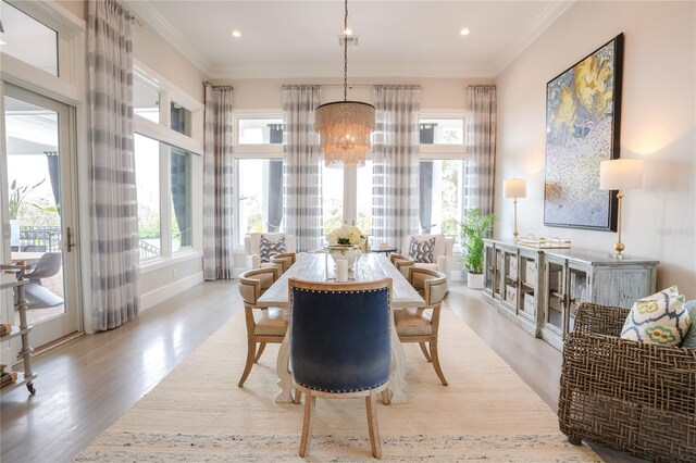 1541 Bay Point Dr, Sarasota, FL 34236 - dining area featuring wood finished floors, a chandelier, ornamental molding, and recessed lighting