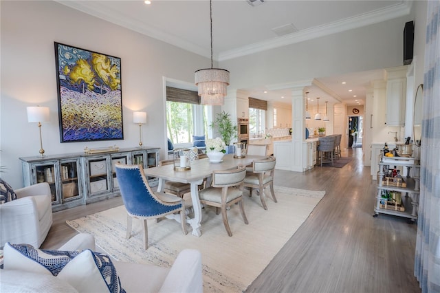 1541 Bay Point Dr, Sarasota, FL 34236 - dining room with light wood finished floors, crown molding, and a chandelier