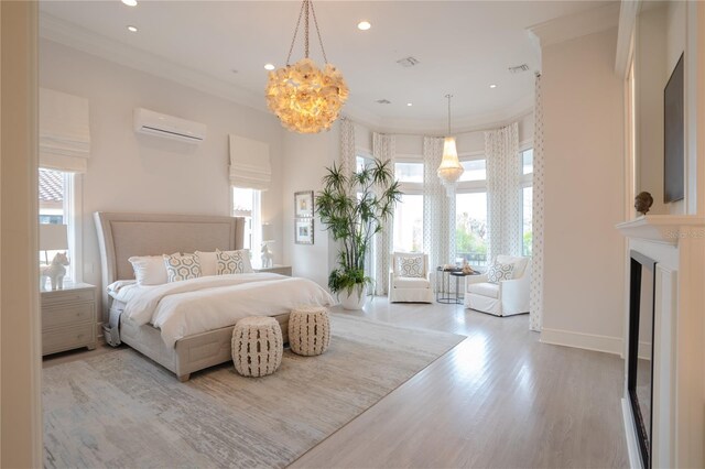 1541 Bay Point Dr, Sarasota, FL 34236 - bedroom featuring a wall mounted AC, ornamental molding, recessed lighting, wood finished floors, and a chandelier