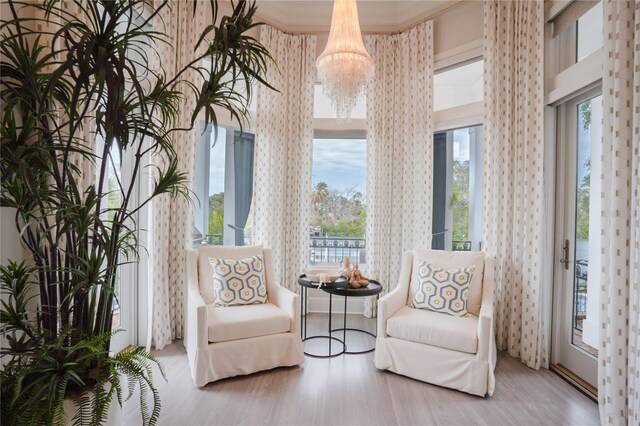 1541 Bay Point Dr, Sarasota, FL 34236 - sitting room with crown molding, wood finished floors, and a chandelier