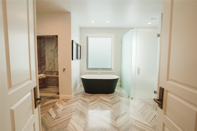 1541 Bay Point Dr, Sarasota, FL 34236 - bathroom featuring a soaking tub, recessed lighting, and a shower stall