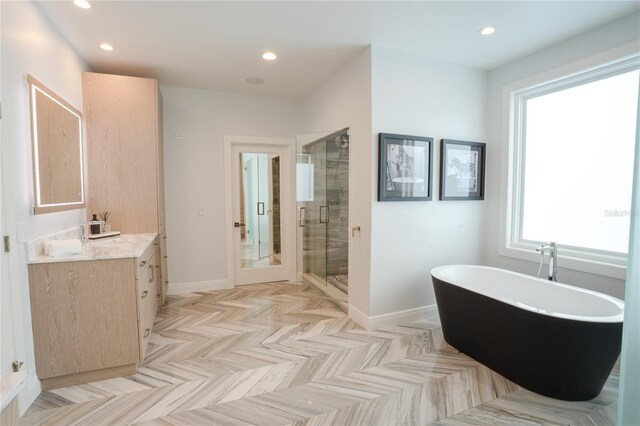 1541 Bay Point Dr, Sarasota, FL 34236 - full bath featuring baseboards, a shower stall, a freestanding bath, recessed lighting, and vanity